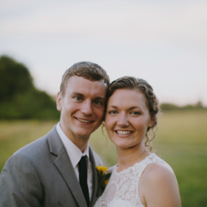 close up bride and groom with field in background