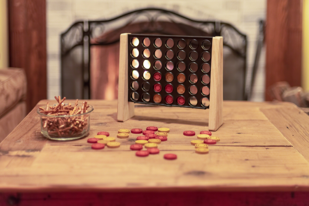 connect four game on coffee table with fireplace in background